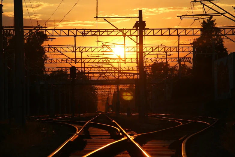 a train track with the sun setting in the background, by Alexander Runciman, pexels contest winner, moscow, terminals, summer morning, screensaver