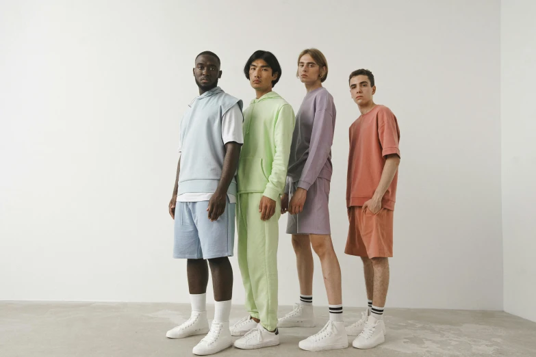 a group of men standing next to each other, trending on pexels, bauhaus, pastel clothing, wearing a tracksuit, wearing shorts and t shirt, 4 colors