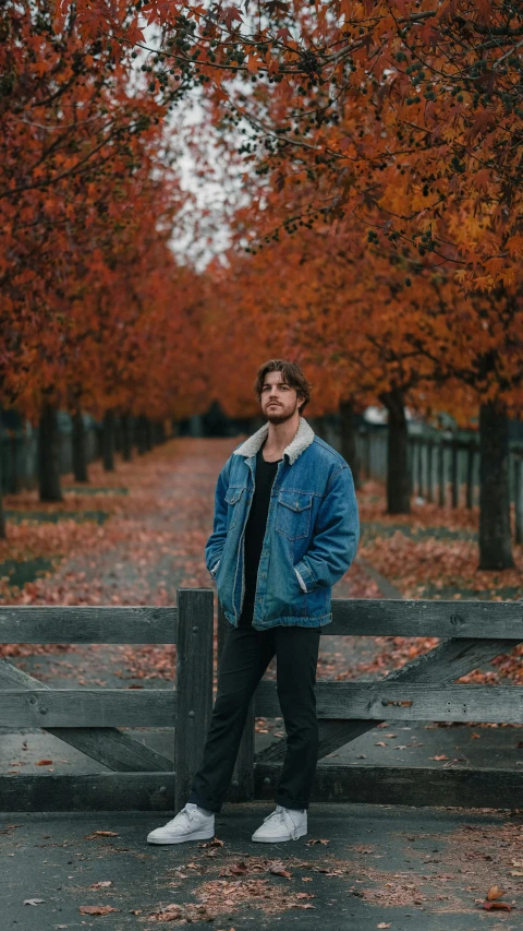 a man standing by a rail in the middle of the road