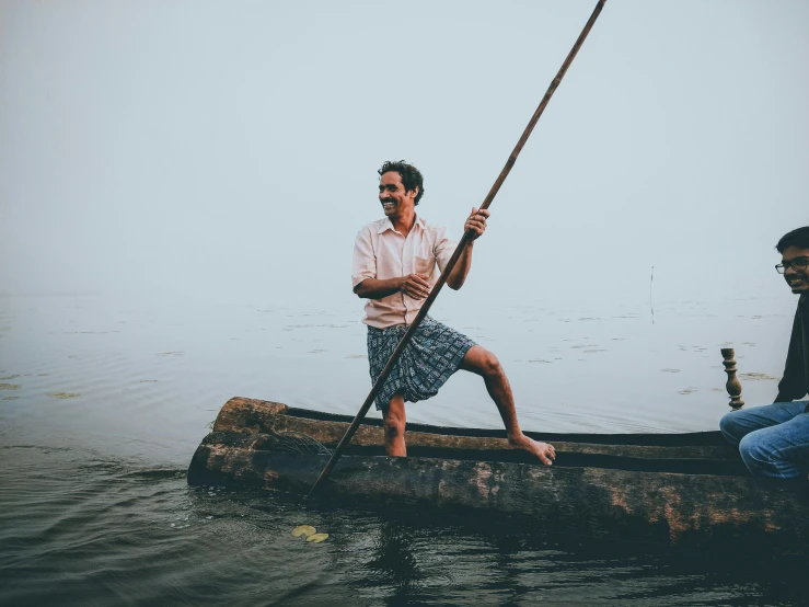 two men in a canoe on a body of water, by Carey Morris, pexels contest winner, renaissance, kerala motifs, full body image, with a happy expression, 4 0 years old man