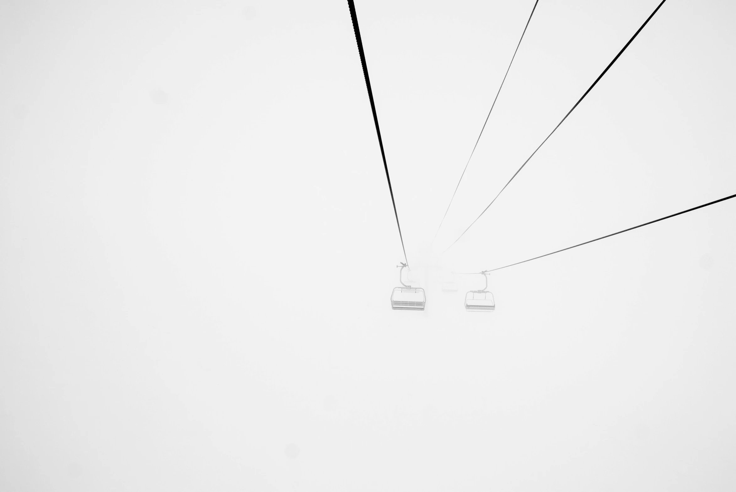 a couple of people riding on top of a ski lift, a black and white photo, by Karl Buesgen, unsplash, minimalism, minimalistic!! simple, white plastic, wire, white in color