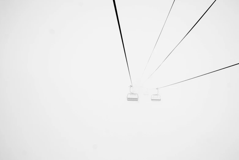 a couple of people riding on top of a ski lift, a black and white photo, by Karl Buesgen, unsplash, minimalism, minimalistic!! simple, white plastic, wire, white in color