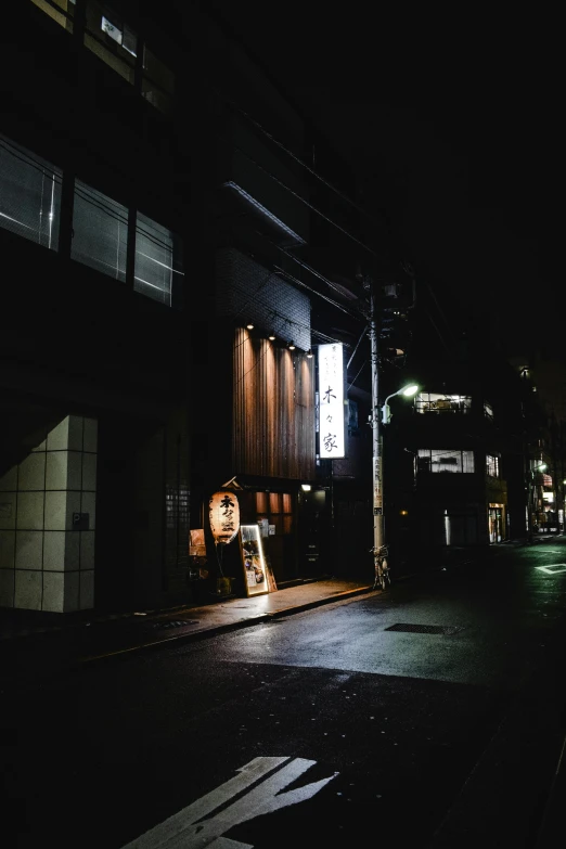 a black and white photo of a street at night, a picture, unsplash, ukiyo-e, outside view, gif, exterior, nightlife