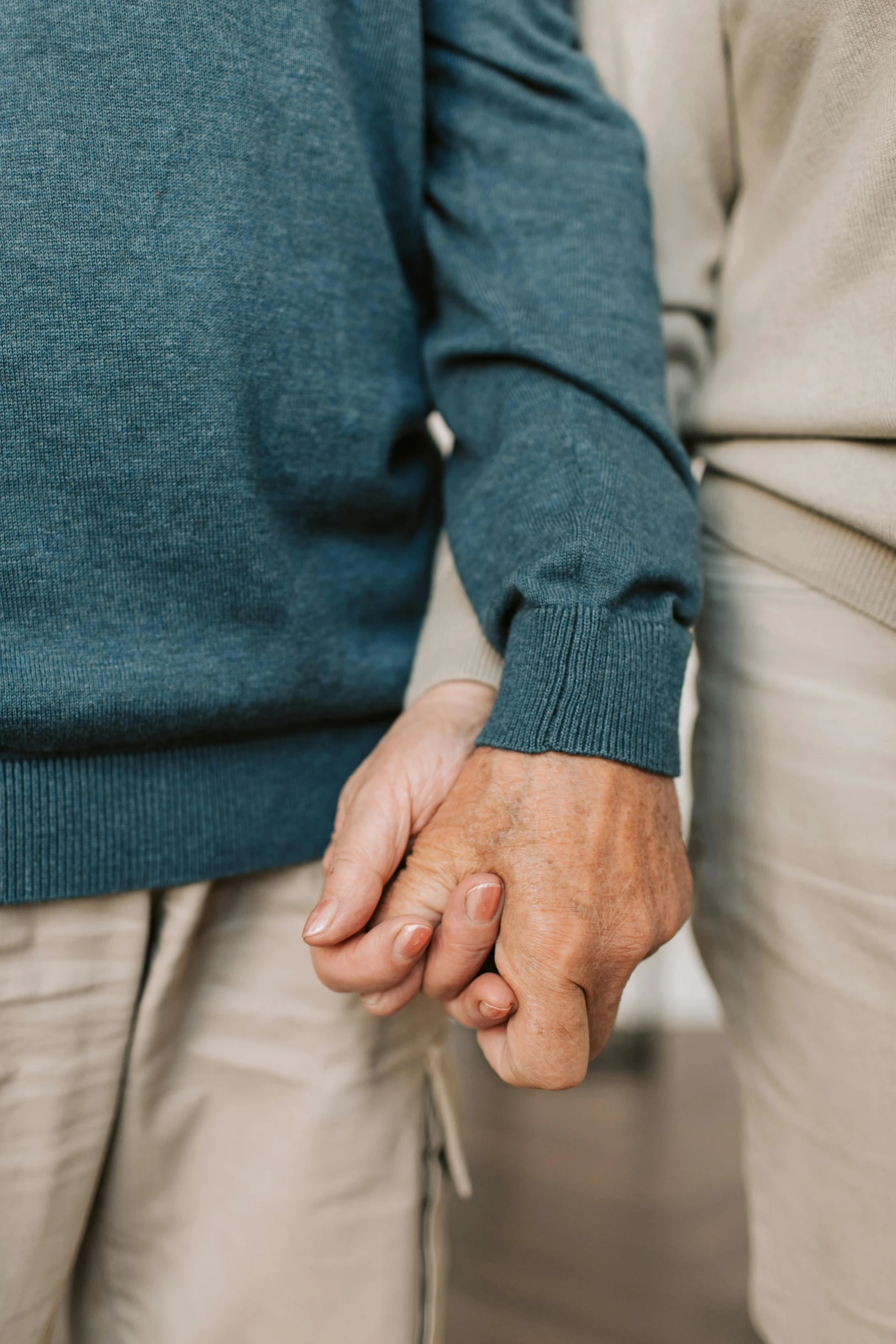 an older woman and older man holding hands