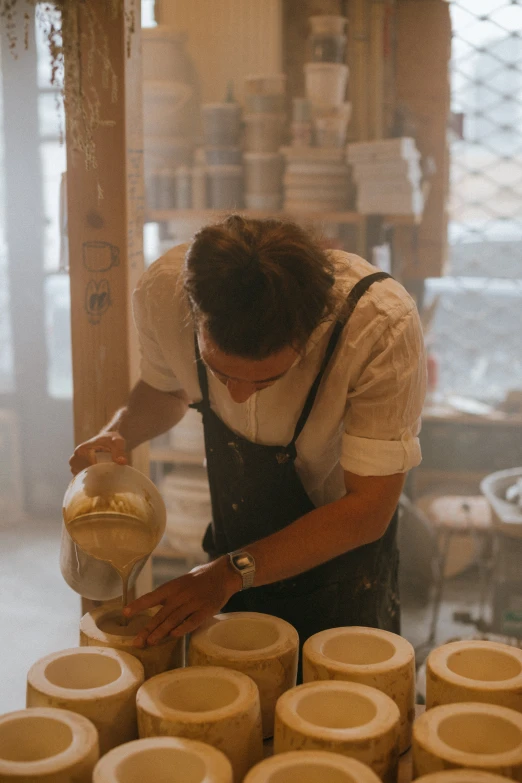 a woman is making a vase out of clay, a portrait, inspired by Hendrik Gerritsz Pot, trending on unsplash, large jars on shelves, thumbnail, plating, lachlan bailey