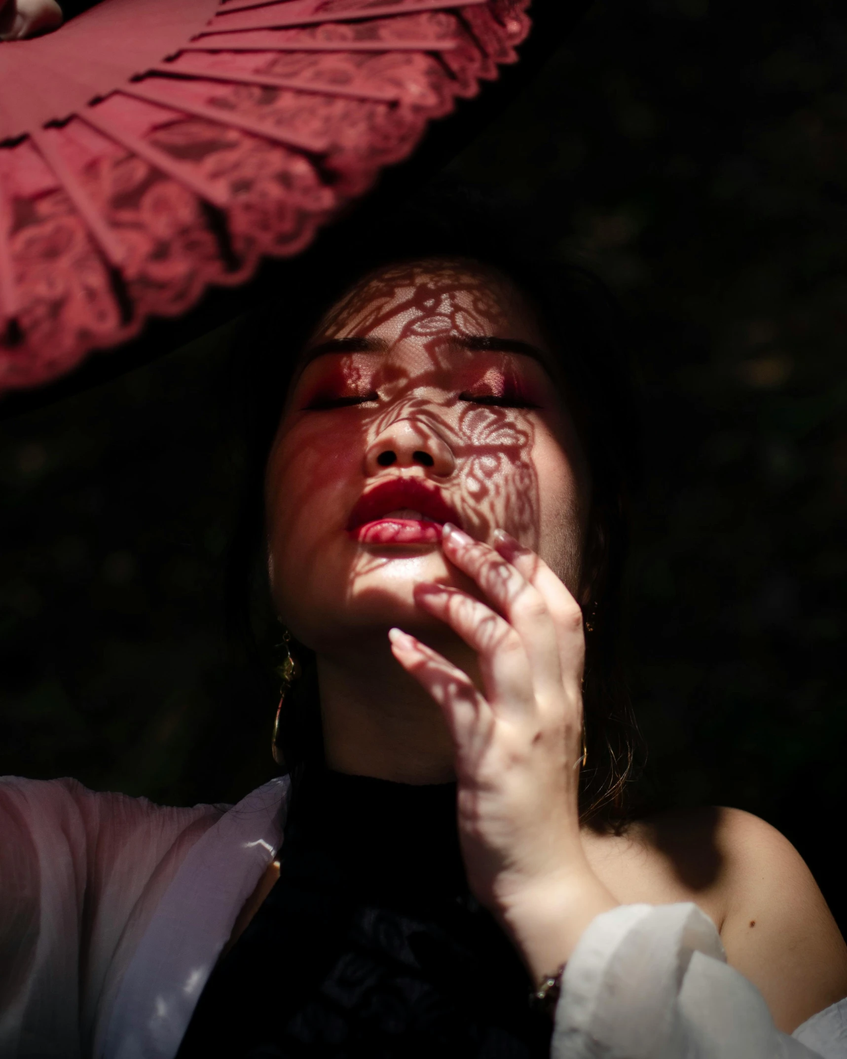 a woman is holding an umbrella and is posing for a picture