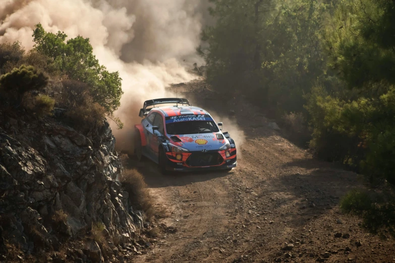 a man driving a red car on a dirt road