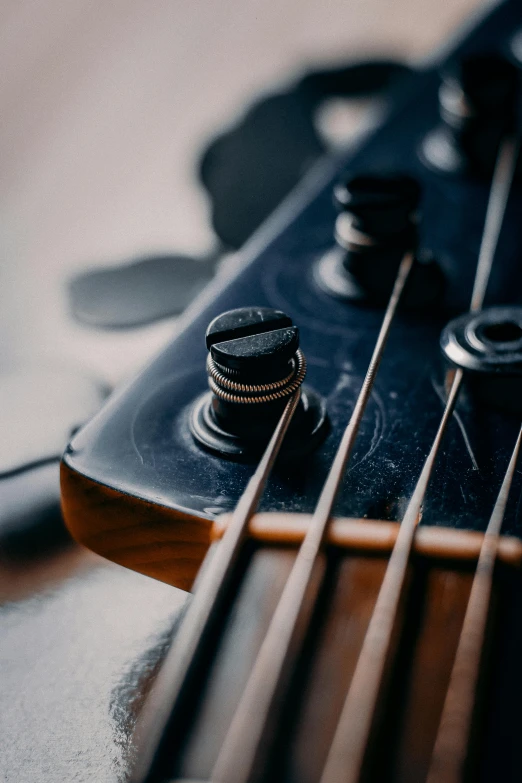 a close up of a guitar neck and strings, an album cover, trending on pexels, bass music, tournament, dark undertones, slightly smiling