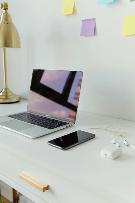 a laptop computer sitting on top of a white desk, by Tom Bonson, trending on pexels, satisfying cable management, photograph of 3d ios room, plain background, morning lighting