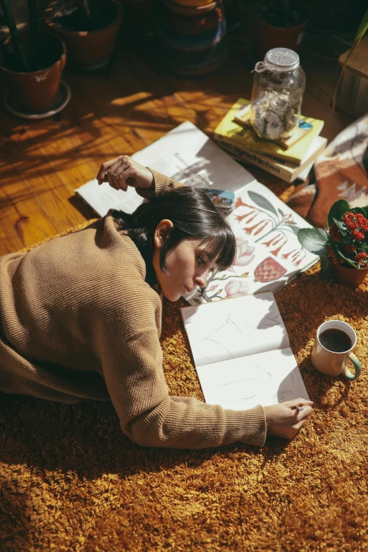 a woman laying on the floor reading a book, a drawing, pexels contest winner, taken with kodak portra, coloring book style, winter sun, korean artist