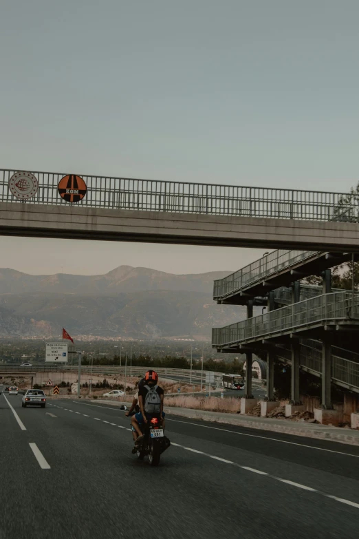 people on motorbikes ride down the highway