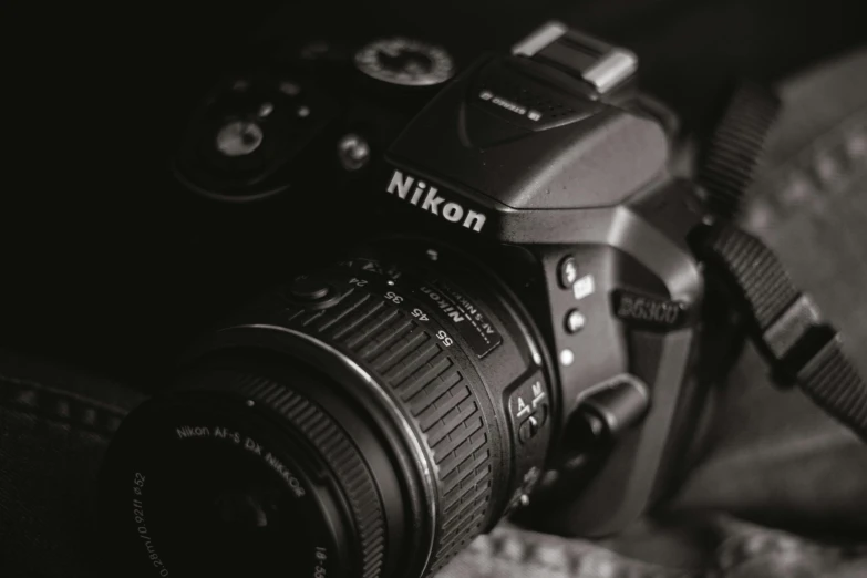 a black and white photo of a camera, by Niko Henrichon, pexels contest winner, photorealism, nikon camera 8 k, today\'s featured photograph 4k, with nikon cameras, close up dslr studio photograph