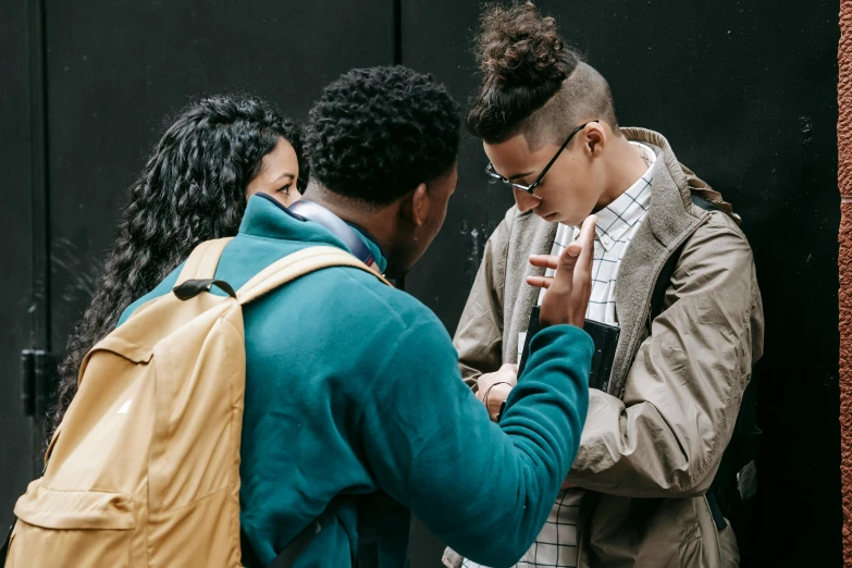 two people who are standing together and talking