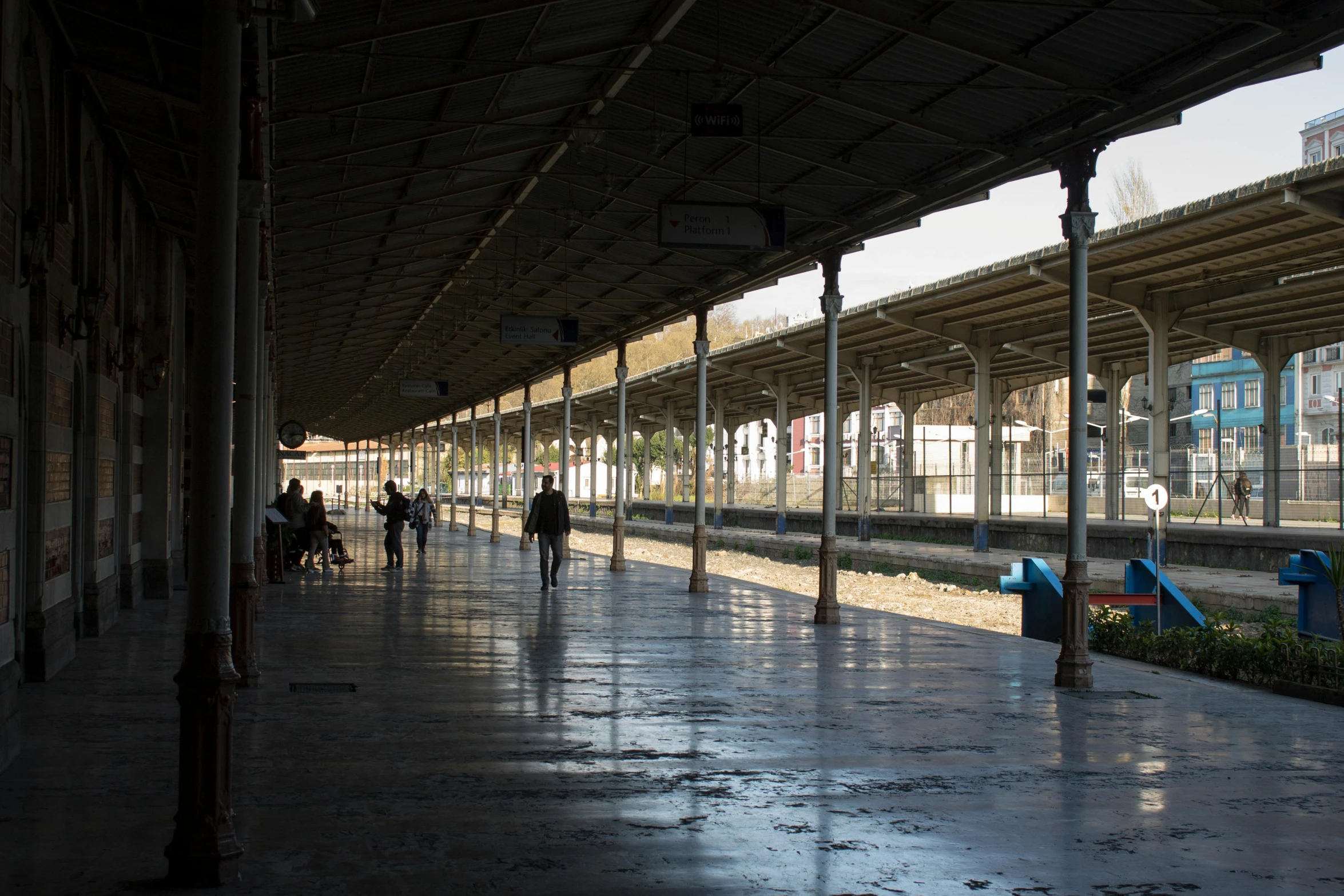 a train station with people walking on the platform, unsplash, arabesque, damascus, nepal, square, depressing