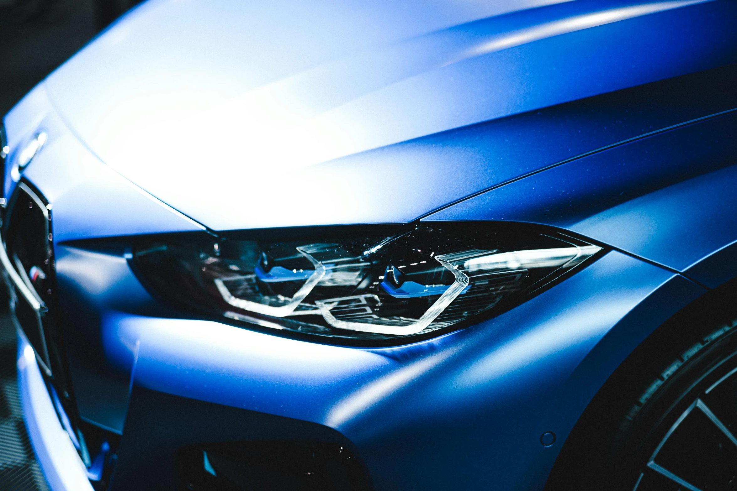 a shiny blue bmw car is shown on display