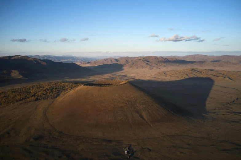 the birds eye view shows a dirt field in the desert