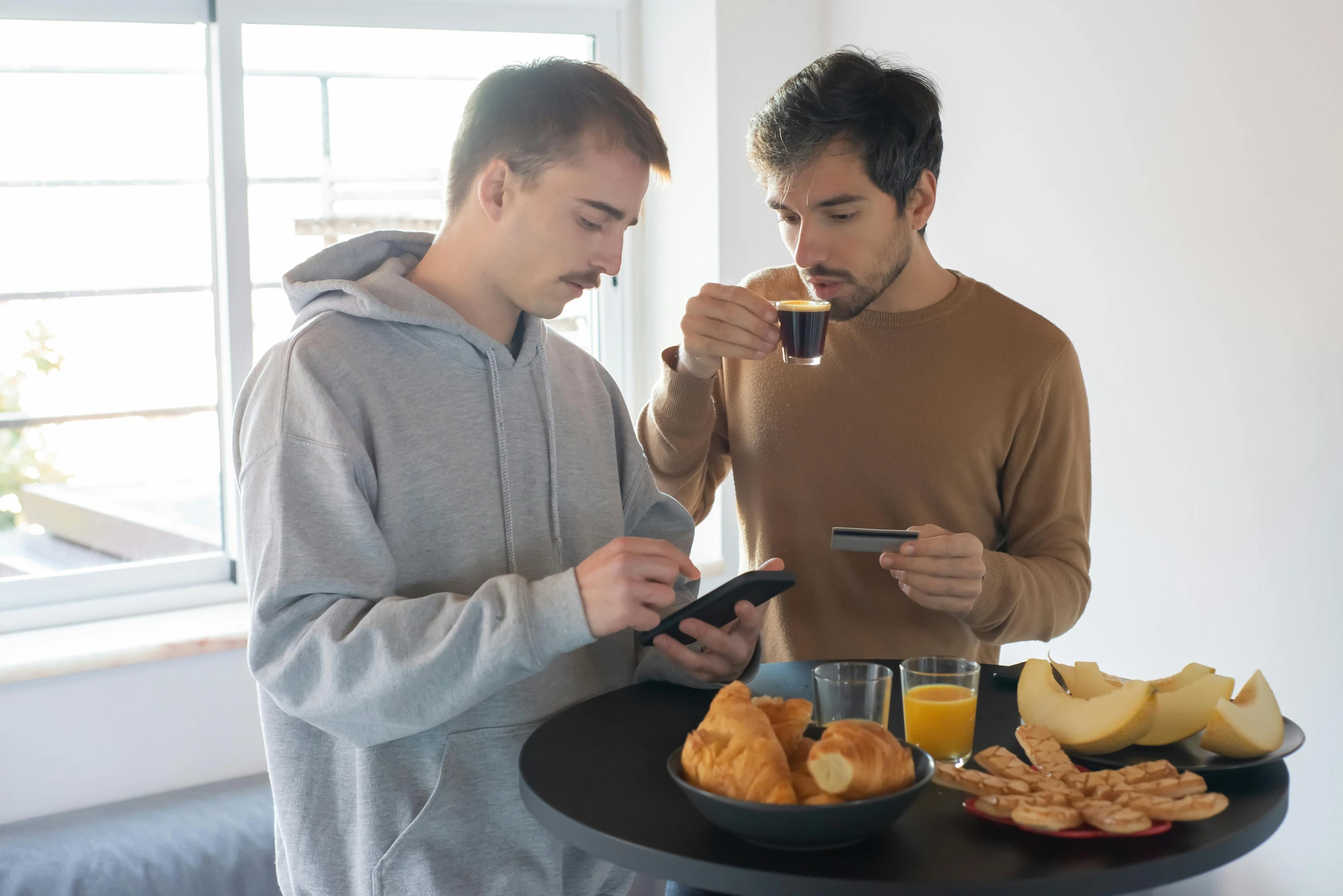 a couple of men standing next to each other at a table, pexels contest winner, scanning items with smartphone, breakfast, avatar image, gay