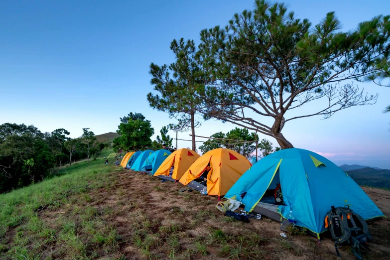 a group of tents sitting on top of a hill, avatar image