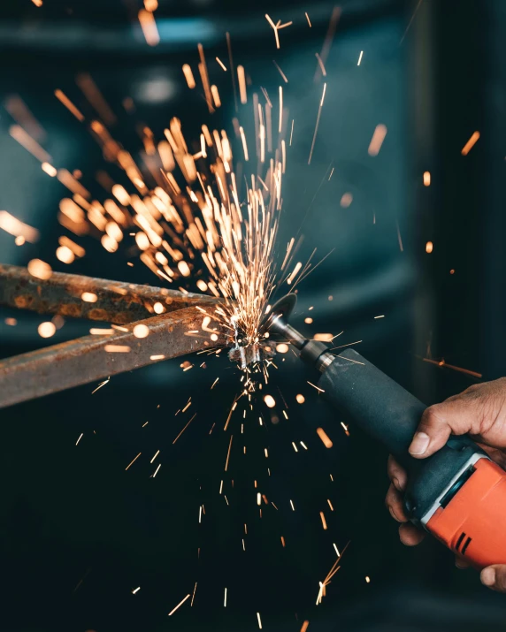 a person using a grinder on a piece of metal, by Adriaen Hanneman, pexels contest winner, happening, celebration, promo image, how pretty, thumbnail