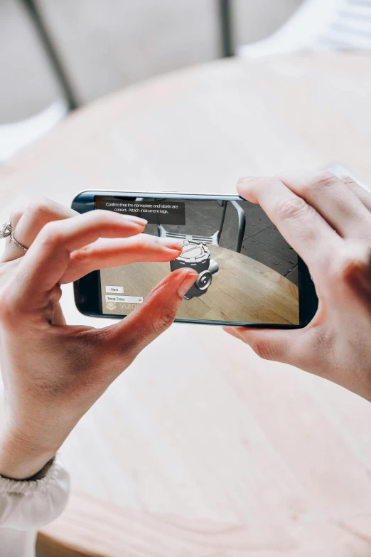 a woman taking a picture with her cell phone, a picture, by Matthias Stom, trending on pexels, photorealism, holographic interface, top down camera angle, made with unreal engine, mobile learning app prototype
