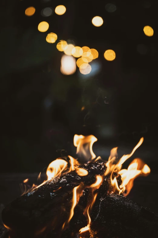 some food is on a black plate next to the fire