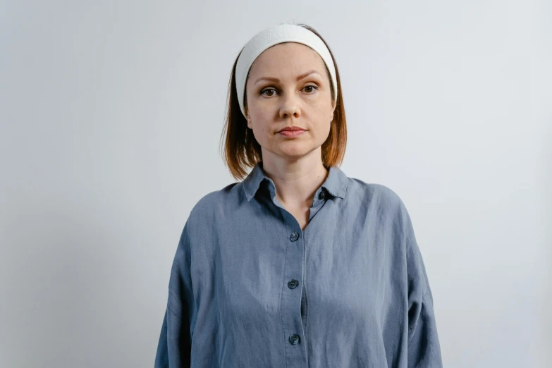 a woman in a blue shirt and a white headband, style of maciej kuciara, with pale skin, clothed in white shirt, lena oxton