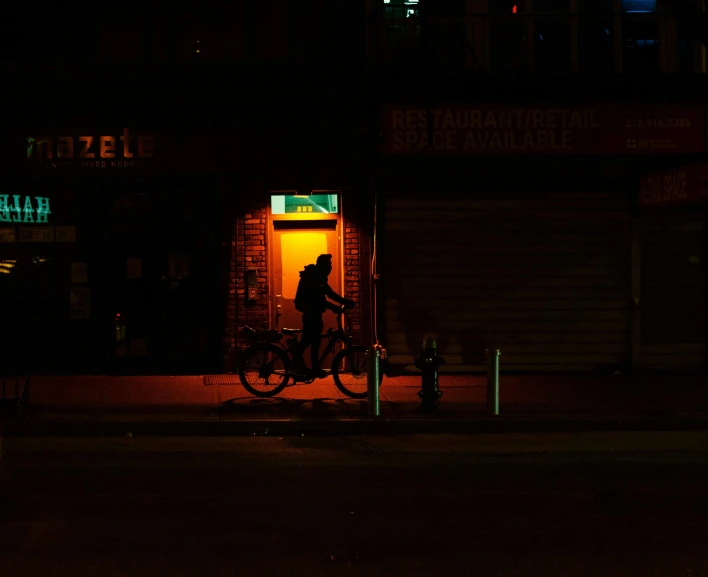 a person standing outside of a building at night, pexels contest winner, australian tonalism, bicycle, dan flavin, outside a saloon, ariel perez