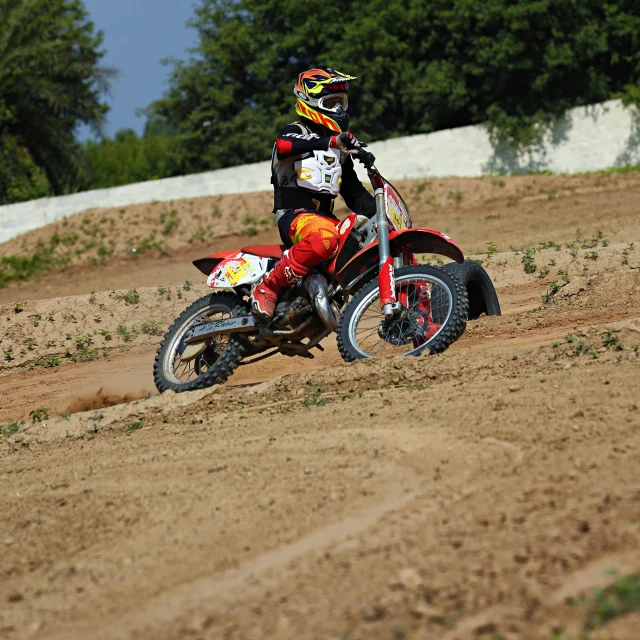 a person riding a dirt bike on a dirt track, profile image