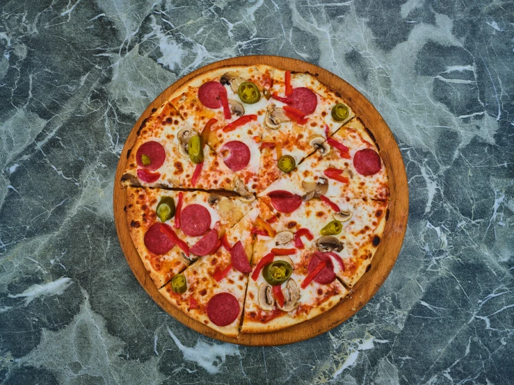 a pizza sitting on top of a wooden cutting board, all marble, vibrant red and green colours, 300mm, volcanic