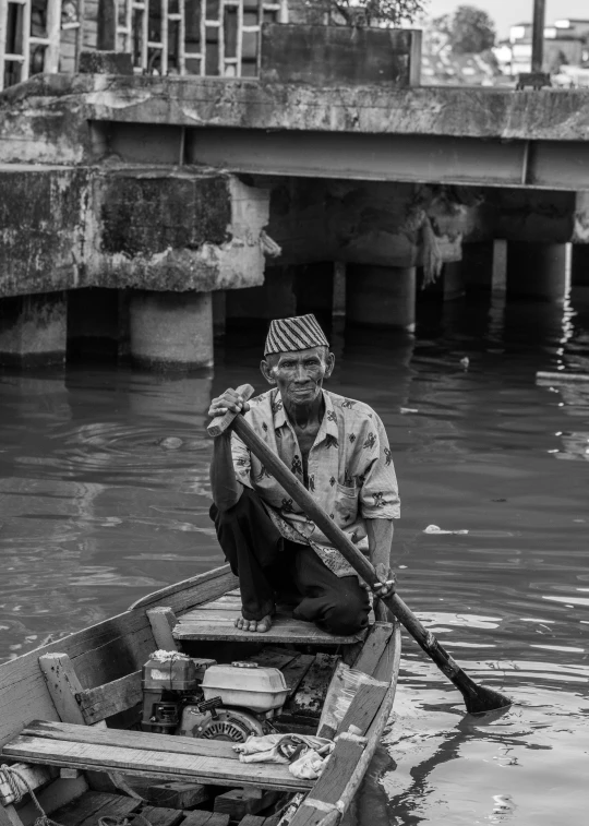 a black and white photo of a man in a boat, a black and white photo, pexels contest winner, selling his wares, * colour splash *, serene smile, working hard