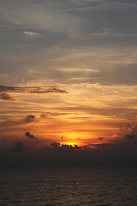 an airplane flies low to the ground near a cloudy sky