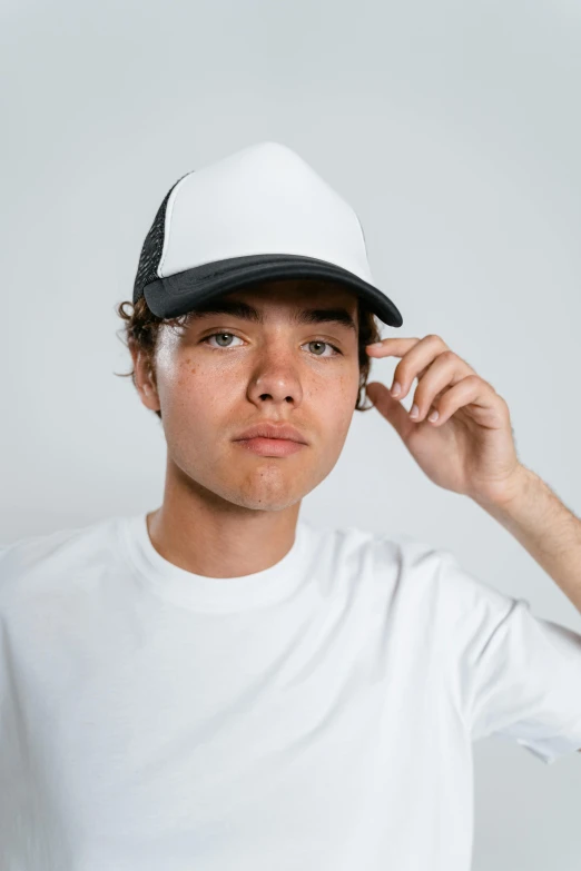 a man is dressed in white and has a black hat