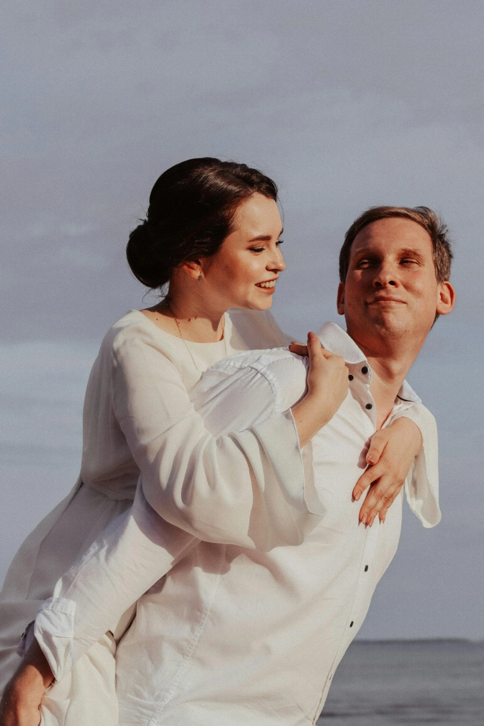 a man carrying a woman on his back on the beach, unsplash, renaissance, wearing a linen shirt, bouguereau style pose, still frame from a movie, wedding