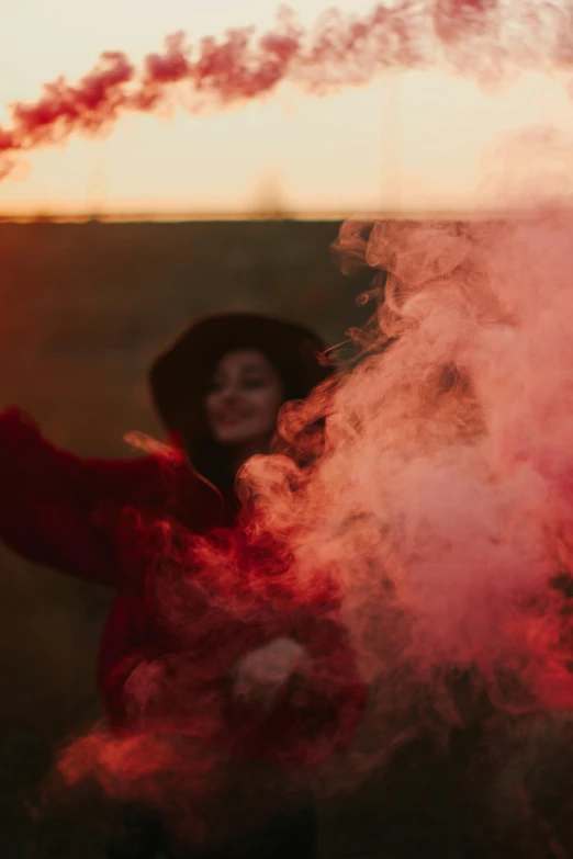 woman standing by red smoke with pink lights