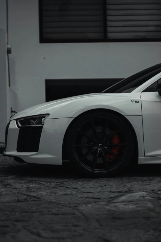 a white car parked in front of a garage