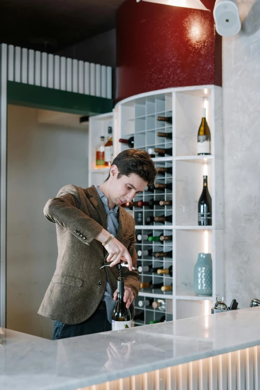 a man pouring a glass of wine at a bar, liam brazier, wine bottle, profile, at checkout