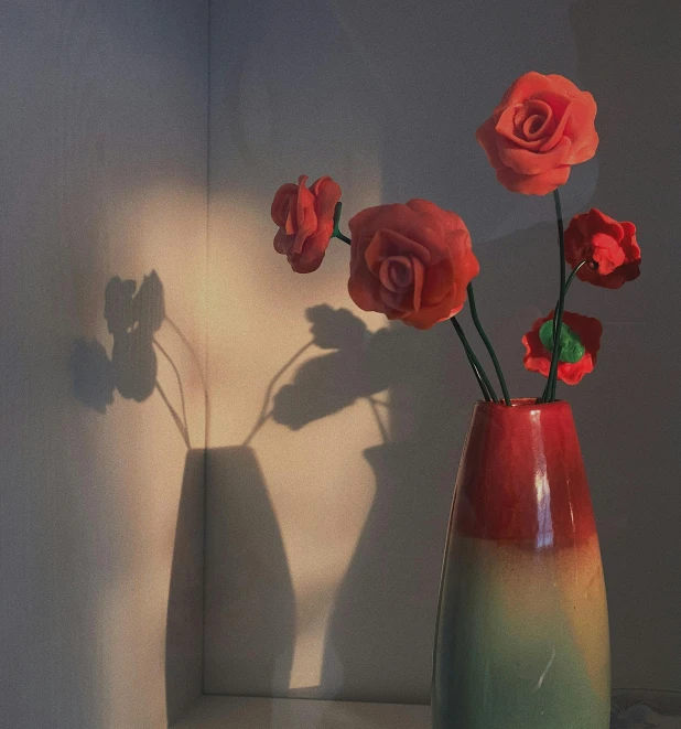red flowers in a vase on a table