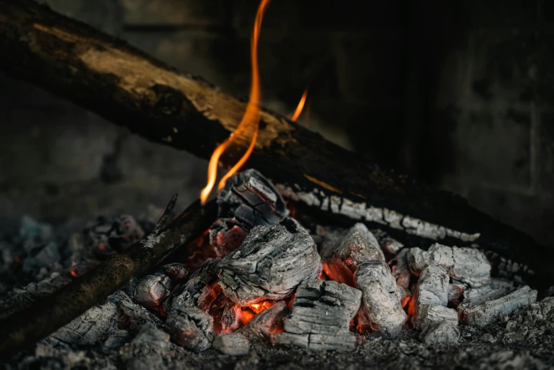 close up of a large pile of coal with  flames burning