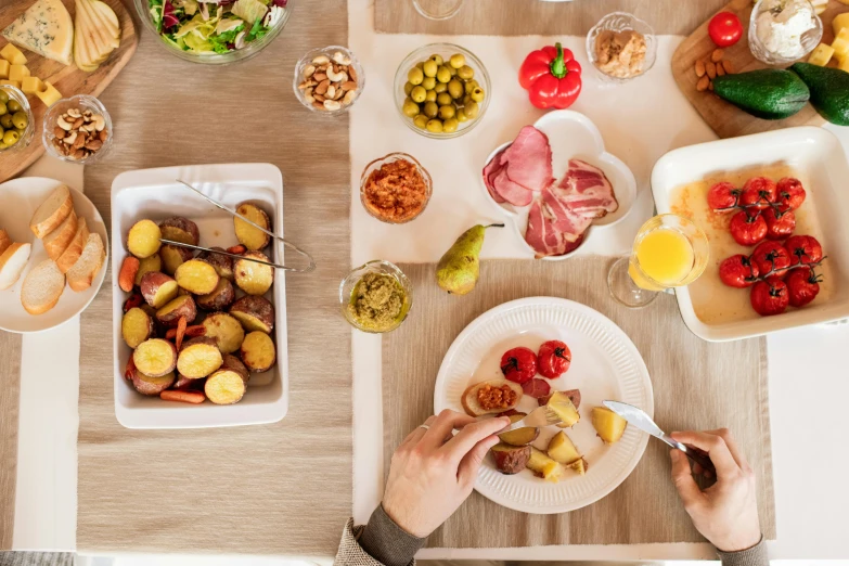 a table topped with plates of food and bowls of fruit