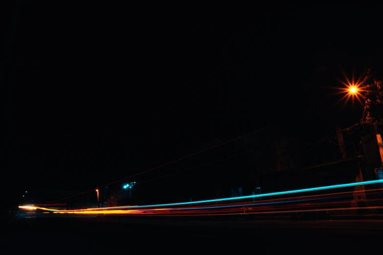 a city street at night with lights all along the sides of the road