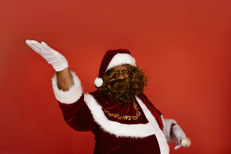 the bearded man in a santa clause suit waves
