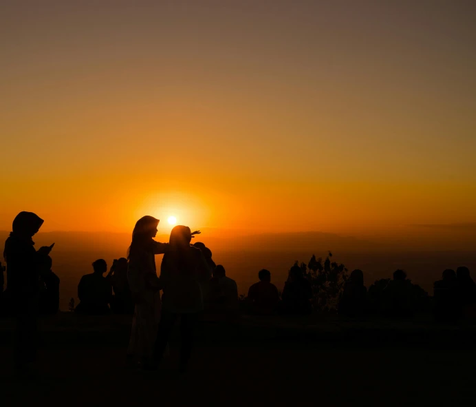a group of people standing on top of a mountain, by Niko Henrichon, pexels contest winner, romanticism, two suns, concert, ((sunset)), telephoto shot