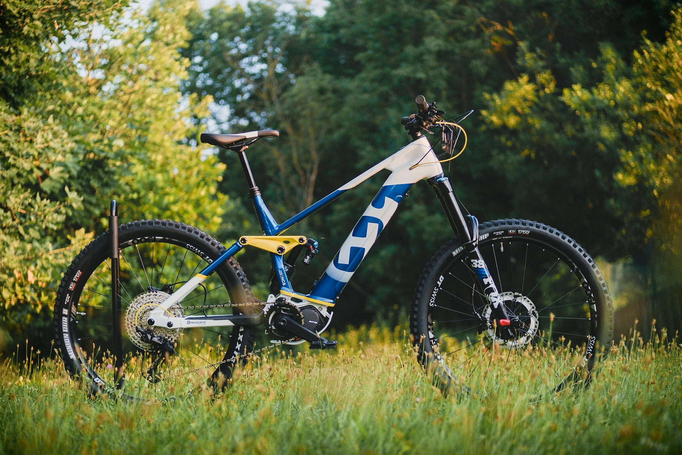 a bike that is sitting in the grass, placed in a lush forest, electric, profile image, low ultrawide shot
