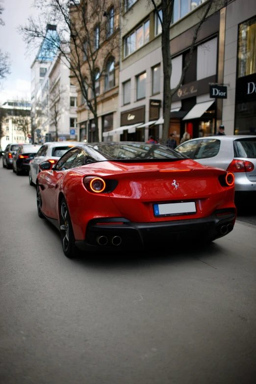 a red sports car parked on the side of a city street