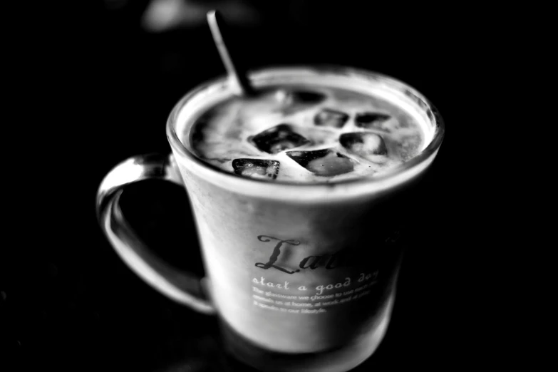 an iced beverage with a straw is placed in a mug