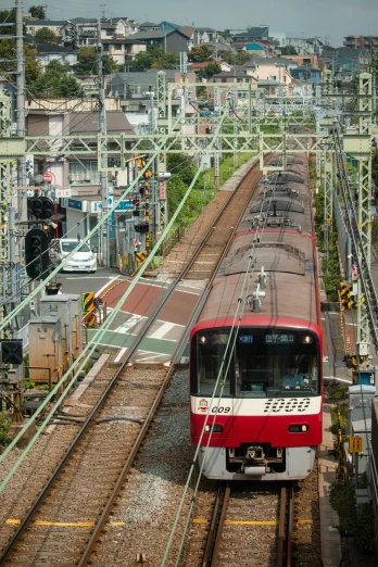 a red and white train traveling down train tracks, sōsaku hanga, machines and wires everywhere, thumbnail, chemrail