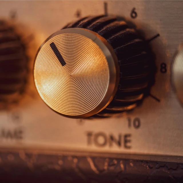 a close up of a knob on a radio, an album cover, by Konrad Witz, trending on pexels, modernism, material brass & copper gold, fender stratocaster, octane highly detailed cinematic, control panel