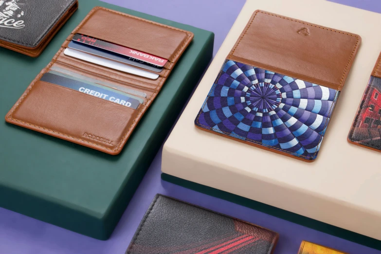 a couple of wallets sitting on top of a table, inspired by Harrington Mann, op art, cards, a wide shot, product display, with colourful intricate