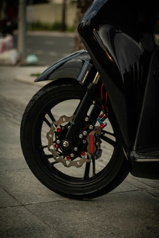 a person riding a motorcycle on a city street, black wheel rims, black steel with red trim, intricate features, moped
