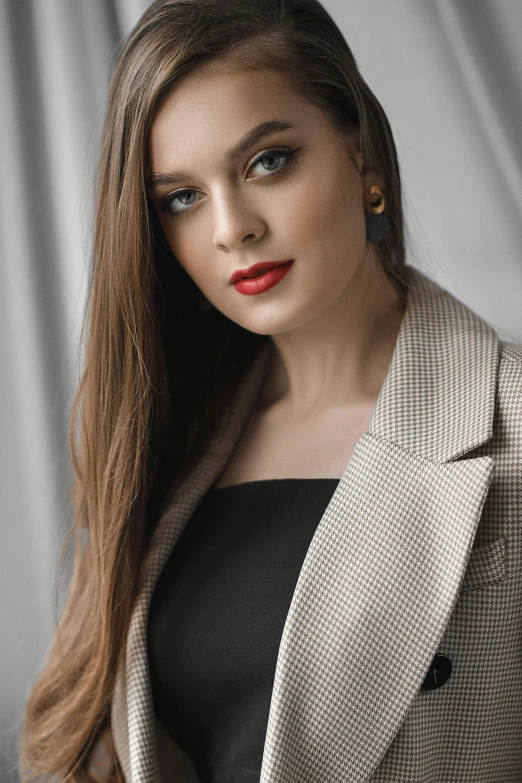 a woman in a suit posing for a picture, brown haired, red lips, wearing a blazer, high resolution image